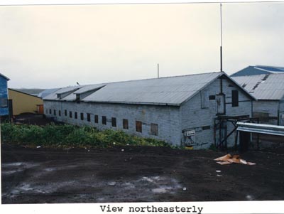 Photo of long white building from a northeasterly view.